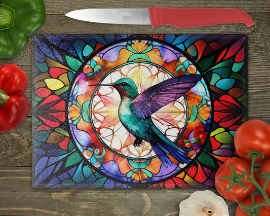 a painting of a hummingbird on a stained glass cutting board