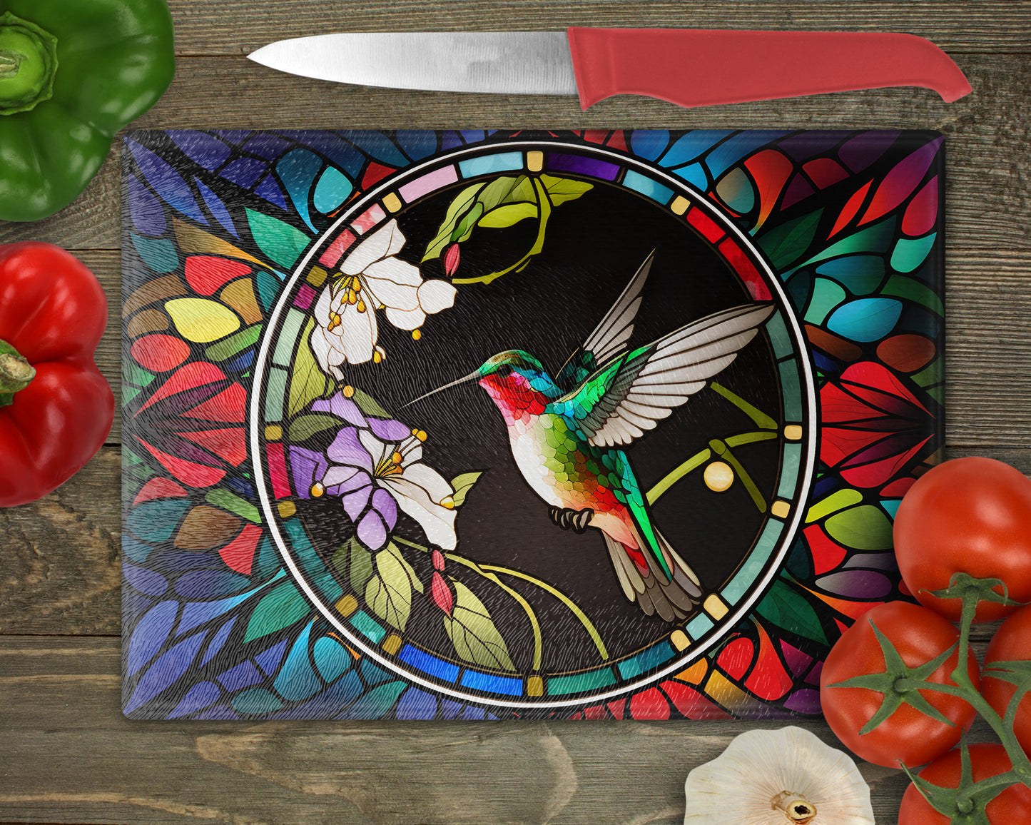 a stained glass cutting board with a hummingbird on it