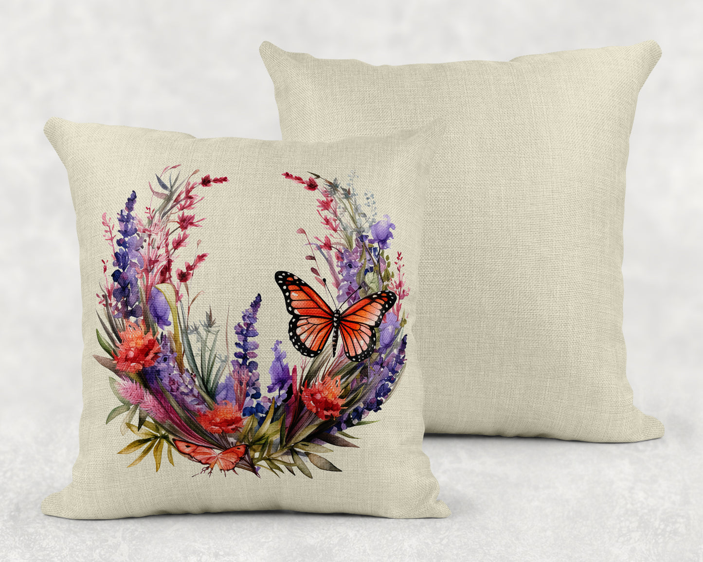 two pillows with a butterfly and flowers on them