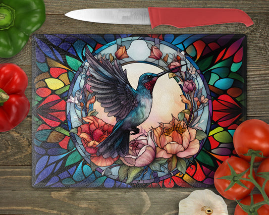 a painting of a hummingbird on a stained glass cutting board