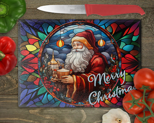 a stained glass cutting board with a picture of santa holding a candle