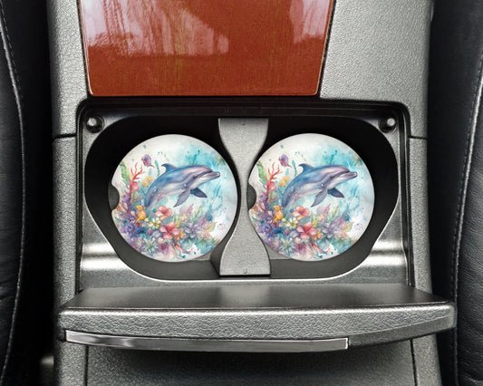 two plates with dolphins painted on them in a car